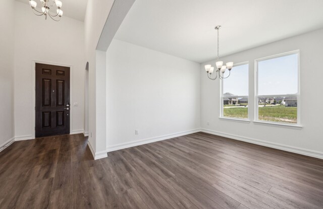 4376 Noble Ln, Midlothian, TX 76065 - entrance foyer featuring a chandelier, arched walkways, and dark wood-style flooring