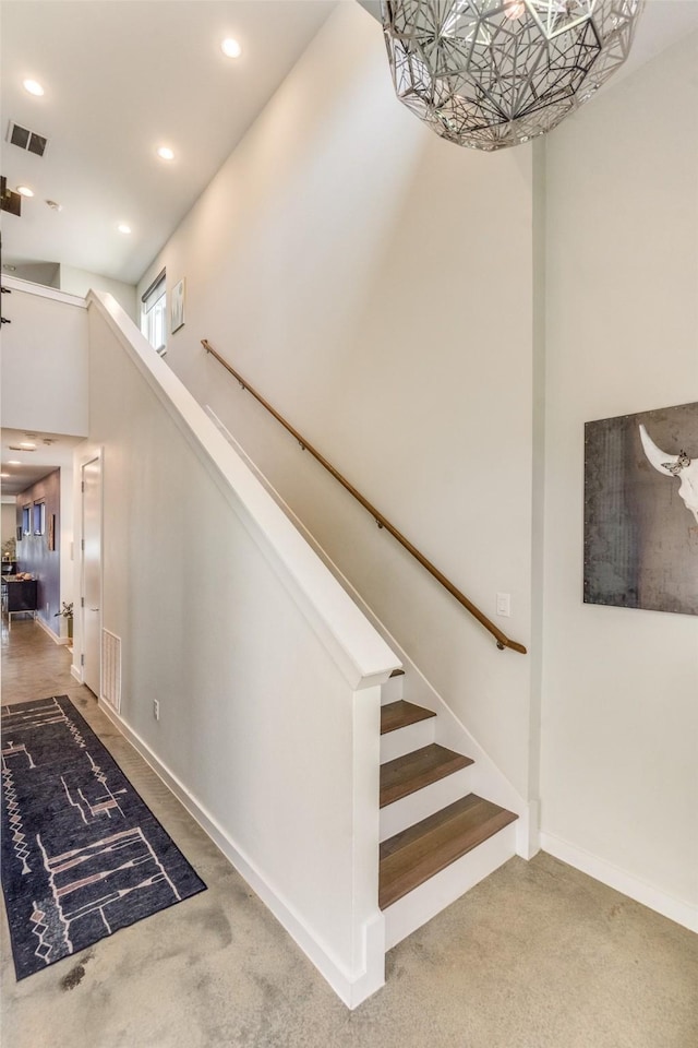 stairway with recessed lighting, visible vents, carpet floors, and baseboards