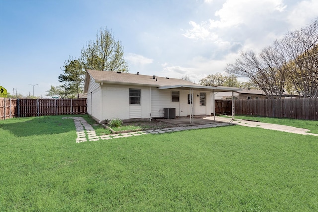 rear view of house with central air condition unit, a patio area, a yard, a fenced backyard, and brick siding