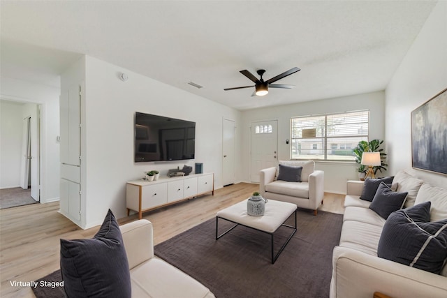 living room featuring a ceiling fan, visible vents, and wood finished floors