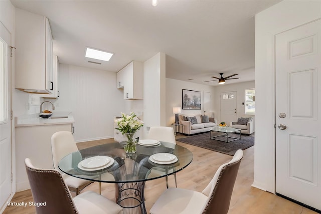 dining area with visible vents, ceiling fan, and light wood finished floors