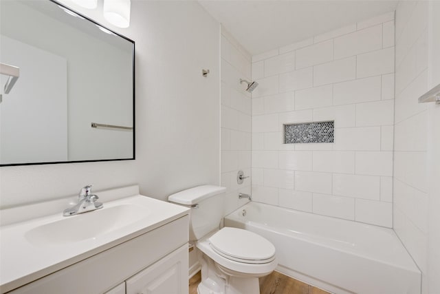 bathroom featuring wood finished floors, toilet,  shower combination, and vanity