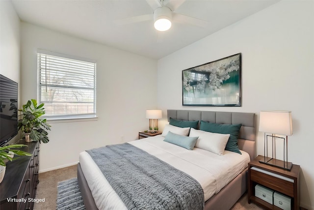 carpeted bedroom featuring a ceiling fan and baseboards