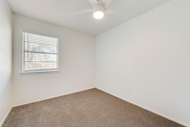 empty room featuring baseboards, ceiling fan, and carpet