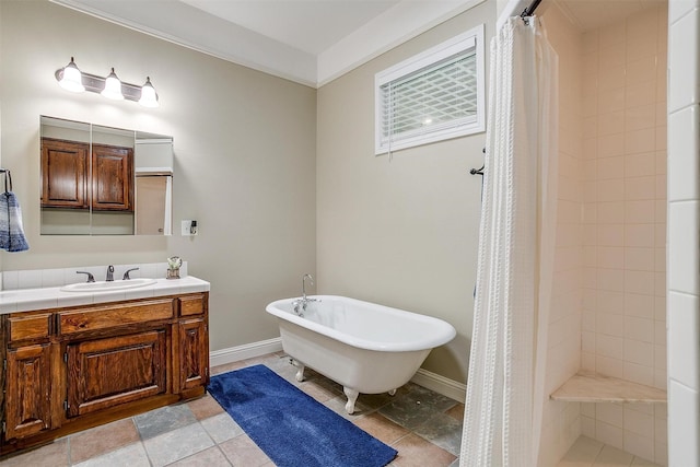 bathroom with a freestanding bath, vanity, baseboards, and a tile shower