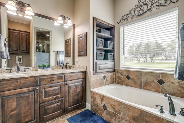 bathroom with a bath, double vanity, a sink, and a shower stall