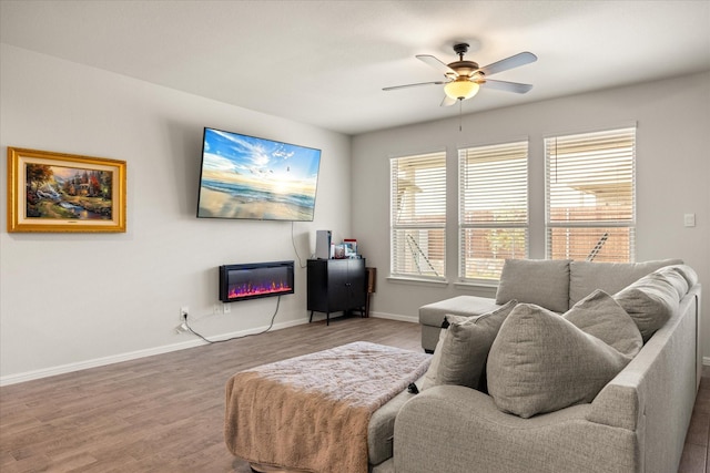 5228 Star Bright Dr, Fort Worth, TX 76179 - living area featuring wood finished floors, a glass covered fireplace, baseboards, and ceiling fan