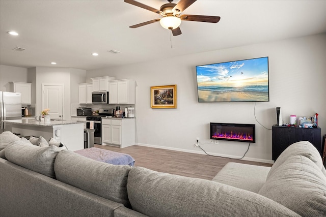 5228 Star Bright Dr, Fort Worth, TX 76179 - living area with light wood-type flooring, recessed lighting, baseboards, ceiling fan, and visible vents