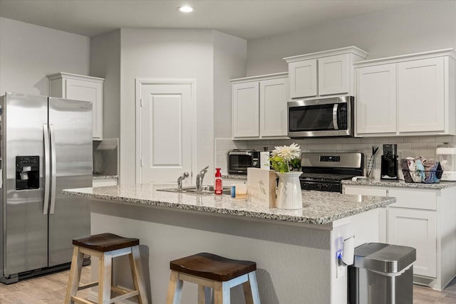 5228 Star Bright Dr, Fort Worth, TX 76179 - kitchen featuring a sink, tasteful backsplash, appliances with stainless steel finishes, and light wood finished floors