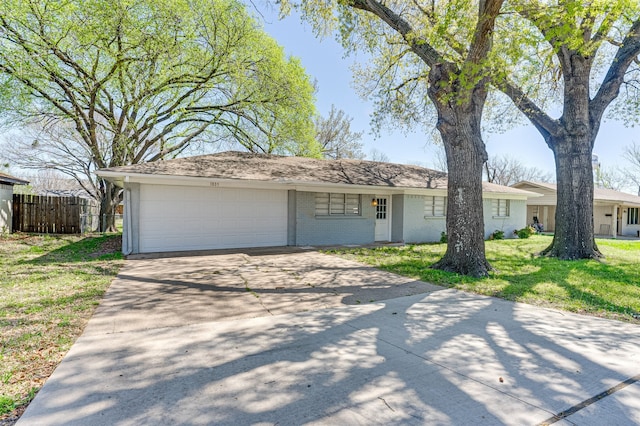 1805 Austin Dr, Kaufman, TX 75142 - ranch-style home with a front yard, fence, brick siding, an attached garage, and driveway