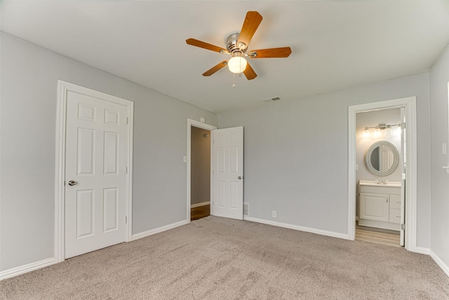 1805 Austin Dr, Kaufman, TX 75142 - unfurnished bedroom featuring ceiling fan, ensuite bath, visible vents, carpet flooring, and baseboards