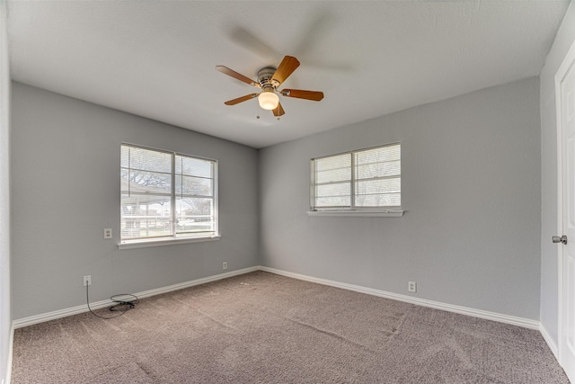 1805 Austin Dr, Kaufman, TX 75142 - carpeted empty room with baseboards, a ceiling fan, and a healthy amount of sunlight
