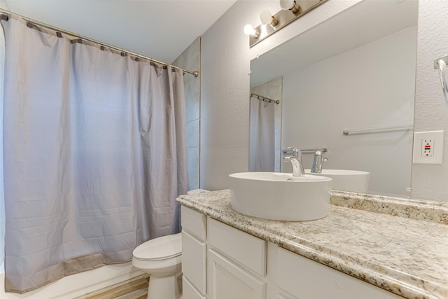 1805 Austin Dr, Kaufman, TX 75142 - bathroom with a textured wall, vanity, a shower with curtain, and toilet