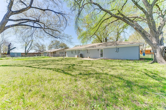 1805 Austin Dr, Kaufman, TX 75142 - back of property with a yard, fence, and brick siding