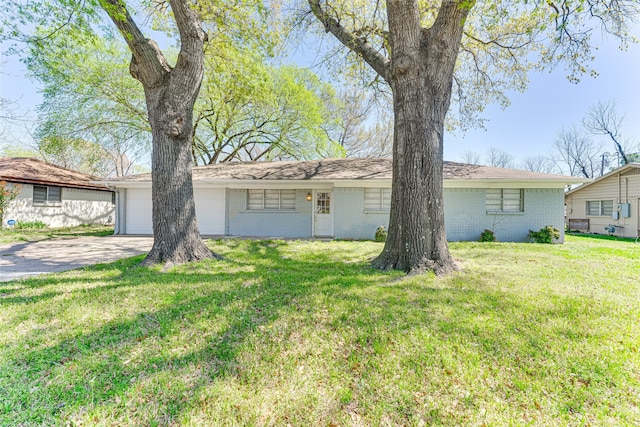 1805 Austin Dr, Kaufman, TX 75142 - single story home with a front yard, brick siding, driveway, and an attached garage