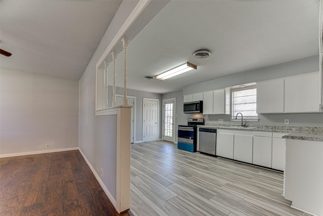 1805 Austin Dr, Kaufman, TX 75142 - kitchen featuring white cabinetry, visible vents, appliances with stainless steel finishes, and light wood-style floors