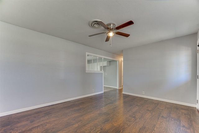 1805 Austin Dr, Kaufman, TX 75142 - spare room featuring dark wood-type flooring, baseboards, and a ceiling fan