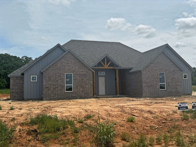 1005 Ronnie Ct, Springtown, TX 76082 - view of front of home with board and batten siding, brick siding, and a shingled roof