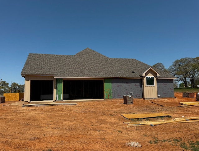 1005 Ronnie Ct, Springtown, TX 76082 - rear view of property with a garage and roof with shingles