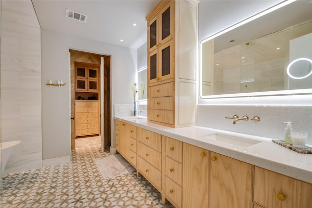 bathroom with a sink, visible vents, walk in shower, and double vanity