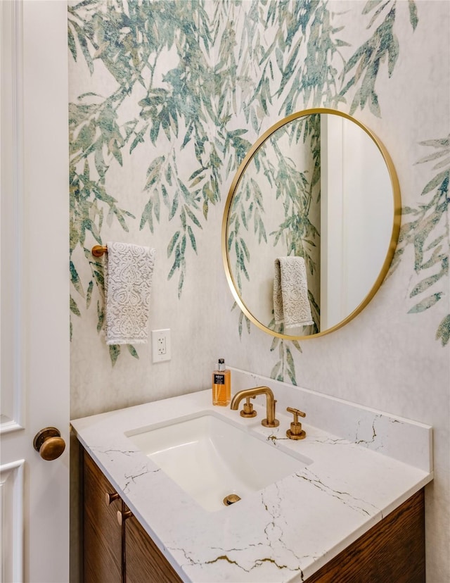 bathroom with vanity and wallpapered walls
