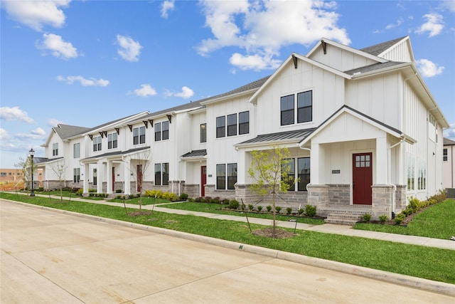 15742 Millwood Trl, Frisco, TX 75033 - view of front of home featuring stone siding, metal roof, a standing seam roof, board and batten siding, and a residential view