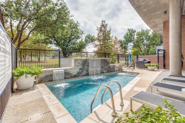view of swimming pool featuring grilling area, a patio, a fenced in pool, and a fenced backyard