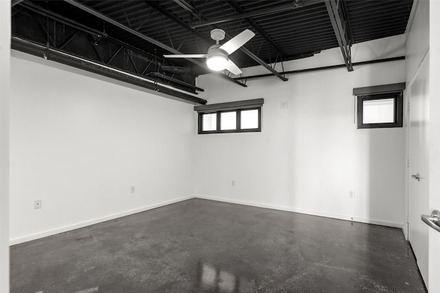 interior space featuring baseboards and ceiling fan