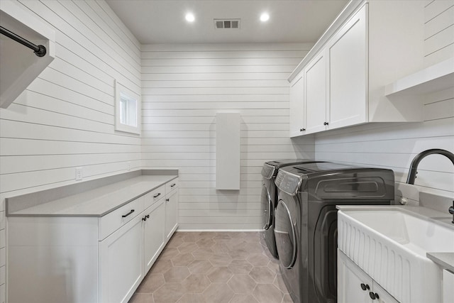 909 Saint Anne Ct, Heath, TX 75032 - clothes washing area with washing machine and dryer, cabinet space, wood walls, light tile patterned floors, and recessed lighting