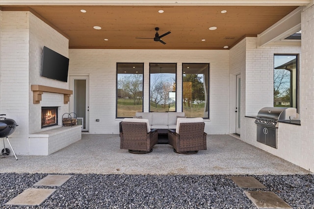 909 Saint Anne Ct, Heath, TX 75032 - view of patio featuring exterior kitchen, area for grilling, and an outdoor living space with a fireplace