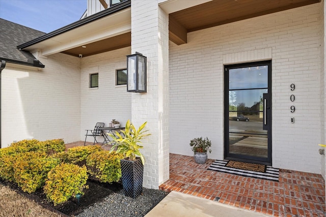 909 Saint Anne Ct, Heath, TX 75032 - view of exterior entry featuring brick siding and a shingled roof
