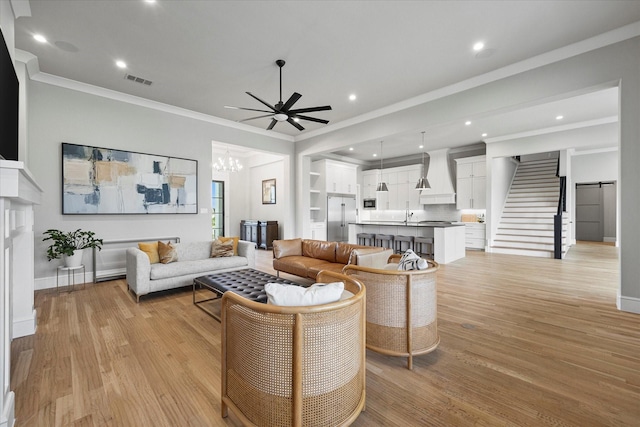 909 Saint Anne Ct, Heath, TX 75032 - living room with light wood-type flooring, crown molding, ceiling fan, stairs, and baseboards