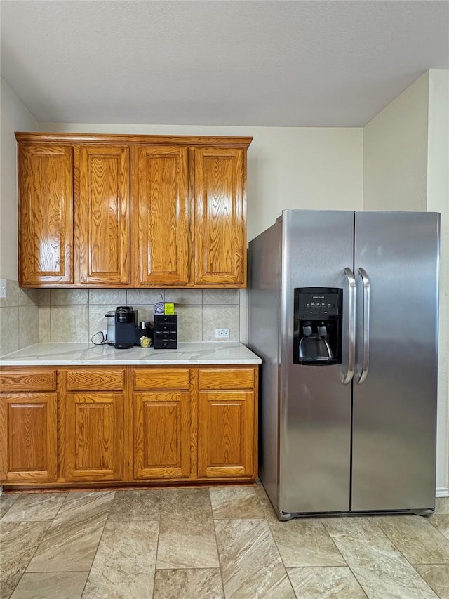 3917 Iris Ct, Mckinney, TX 75070 - kitchen with stainless steel fridge, brown cabinets, and light countertops