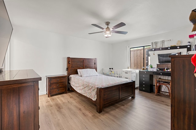 bedroom with a ceiling fan, baseboards, and light wood finished floors