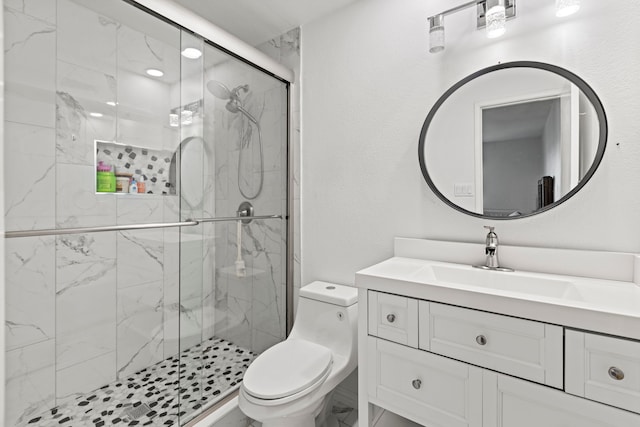 bathroom featuring toilet, vanity, and a marble finish shower