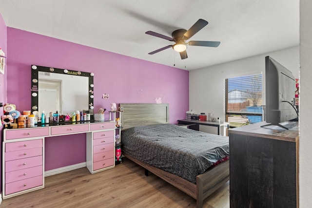 bedroom with wood finished floors and a ceiling fan