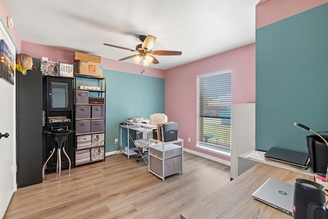 office space featuring baseboards, wood finished floors, and a ceiling fan