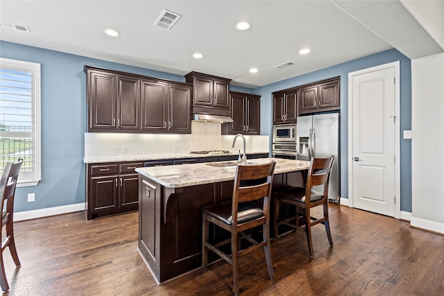 1630 Old Oak Ct, Prosper, TX 75078 - kitchen with stainless steel appliances, dark brown cabinetry, dark wood-style floors, and recessed lighting