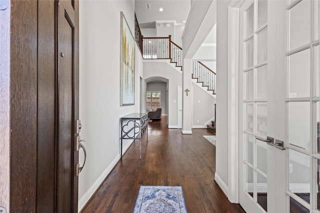 1630 Old Oak Ct, Prosper, TX 75078 - entrance foyer featuring arched walkways, dark wood-type flooring, stairs, and a high ceiling