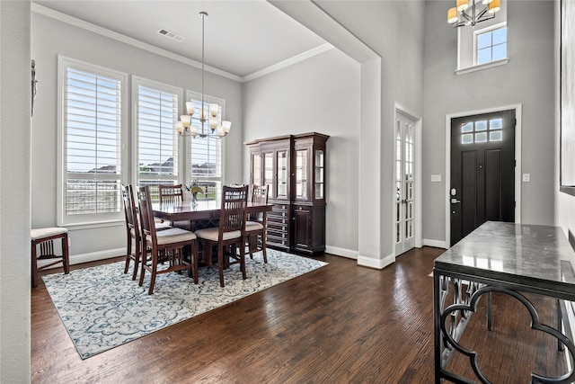 1630 Old Oak Ct, Prosper, TX 75078 - dining area featuring a chandelier, dark wood-type flooring, a towering ceiling, and crown molding