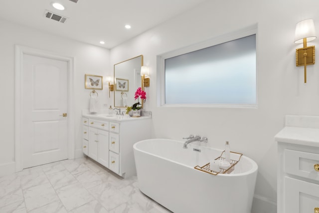 bathroom featuring vanity, a freestanding tub, recessed lighting, marble finish floor, and visible vents