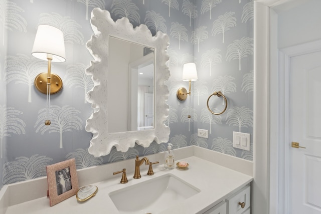bathroom with wallpapered walls and vanity