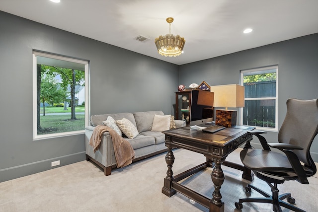 office featuring light colored carpet, recessed lighting, baseboards, visible vents, and a notable chandelier