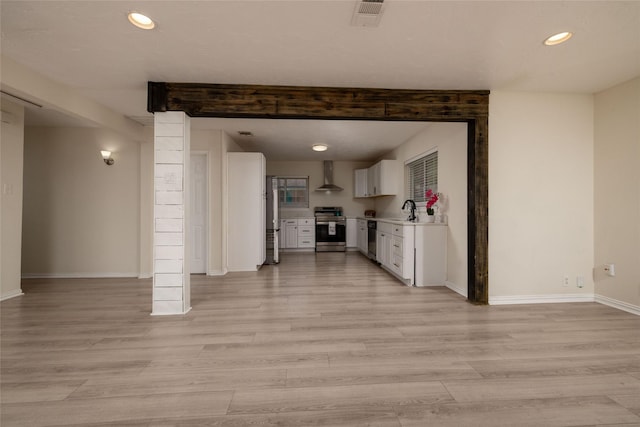 unfurnished living room with baseboards, light wood finished floors, visible vents, and recessed lighting
