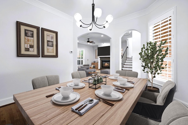 4929 Alcott St, Dallas, TX 75206 - dining space with arched walkways, a glass covered fireplace, a chandelier, wood finished floors, and baseboards