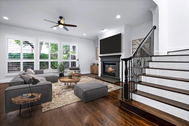 4929 Alcott St, Dallas, TX 75206 - living area with crown molding, a ceiling fan, a glass covered fireplace, wood finished floors, and stairs