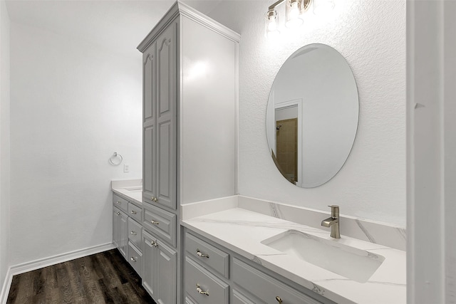 2858 Waters Edge, Quinlan, TX 75474 - full bath featuring baseboards, vanity, and wood finished floors