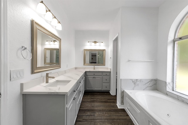 2858 Waters Edge, Quinlan, TX 75474 - full bath with a bath, wood finished floors, a sink, and double vanity