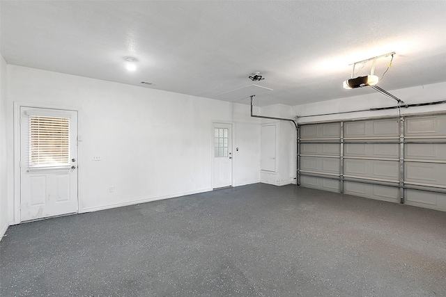 2858 Waters Edge, Quinlan, TX 75474 - garage with a garage door opener, visible vents, and baseboards
