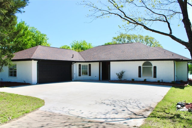 2858 Waters Edge, Quinlan, TX 75474 - single story home with concrete driveway, an attached garage, brick siding, and roof with shingles
